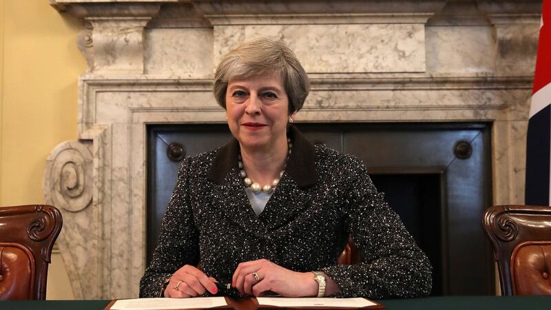 UK prime minister Theresa May in the cabinet signs the Article 50 letter, as she prepares to trigger the start of the UK’s formal withdrawal from the EU. Photograph: Christopher Furlong/PA Wire