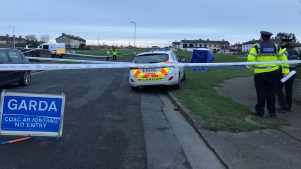 Gardaí at the scene in Coolock on Tuesday morning where a bag containing human limbs was found. Photograph: Dara Mac Dónaill