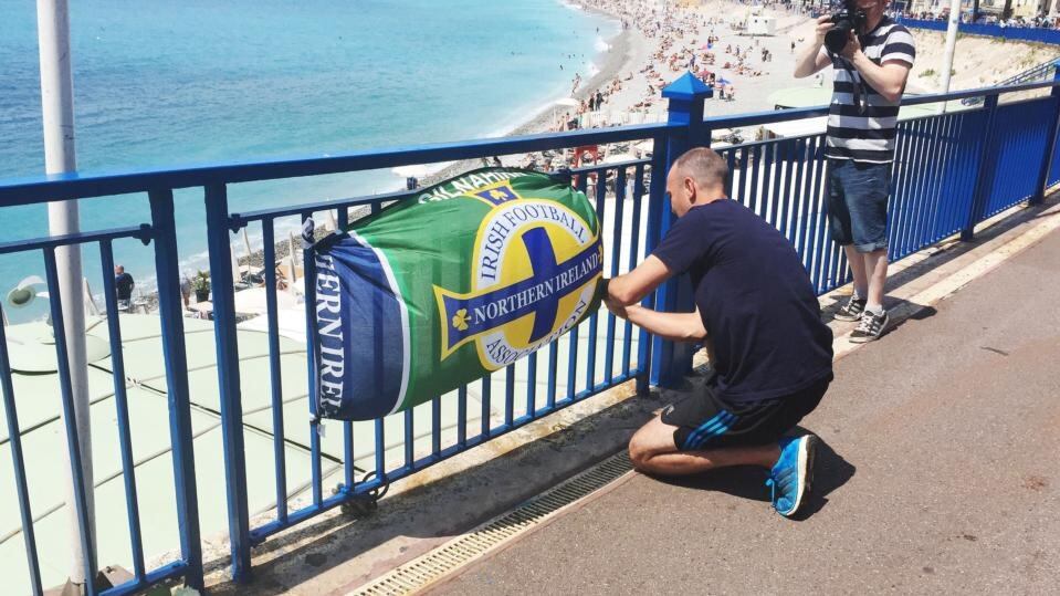 Flowers and a banner are left close to the scene where Darren Rodgers, from Ballymena, died after a fall in Nice in France. Photograph: Michael McHugh/PA Wire