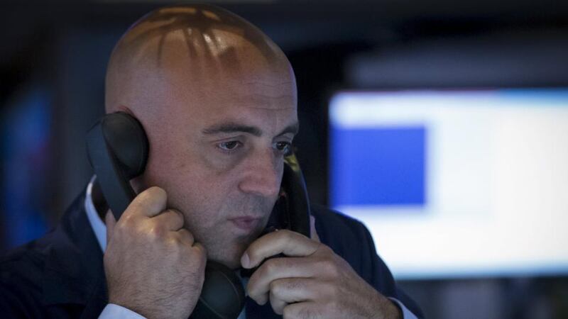 A trader works inside a booth on the floor of the New York Stock Exchange. Photograph: Reuters