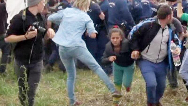 Video grab showing Hungarian camera operator Petra Laszlo kicking a child as she ran with other migrants from a police line near Roszke, Hungary. Photograph:. AFP Photo/Getty Images