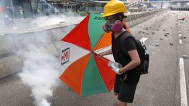 Hong Kong police use tear gas to break up protesters as thousands take to streets