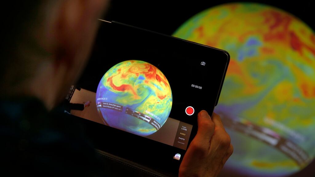 A woman takes a picture of a globe at the COP21, the United Nations Climate Change Conference in France. The UN Framework Convention on Climate Change wants everyone to pursue “sustainable lifestyles”. Photograph: Christophe Ena/PA