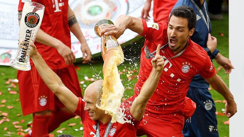 Mats Hummels pours a beer over Arjen Robben as they celebrate winning the Bundesliga. Photograph: Reuters