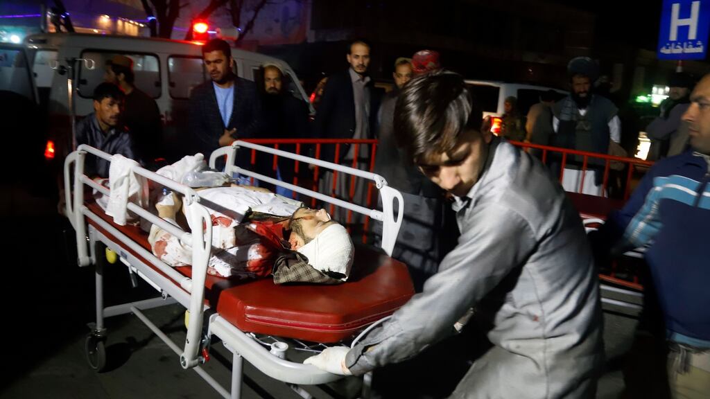 Afghan health workers carry an injured person outside the emergency hospital after a suicide attack targeted a wedding hall, in Kabul, Afghanistan. Photograph: Jawad Jalali/EPA