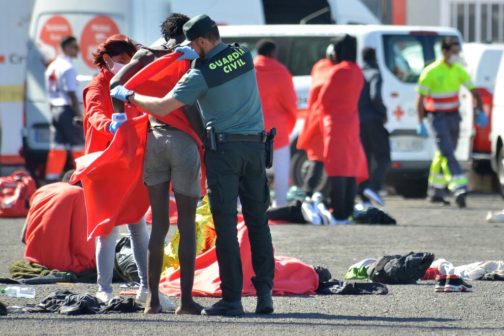 Emergency personnel give blankets to migrants on the Canary Island of El Hierro. Photograph: STRINGER/AFP via Getty Images
