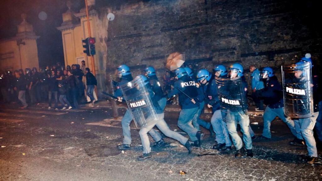 Policemen in riot gear chase protesters outside the Society of St Pius X headquarters, a schismatic Catholic group, where the funeral of former Nazi war-criminal Erich Priebke was scheduled to take place in Albano Laziale, on Tuesday. Photograph: Riccardo De Luca/AP