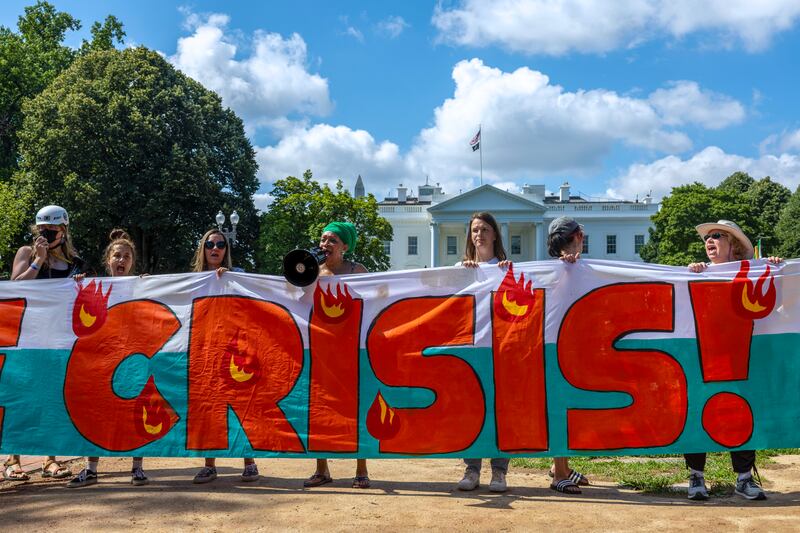 Climate activists chant as they occupy Lafayette Park in front of the White House with a 120ft banner demanding President Joe Biden act on climate change earlier this week, in Washington, DC - a week when record world temperatures were recorded. Photograph: Tasos Katopodis/Getty