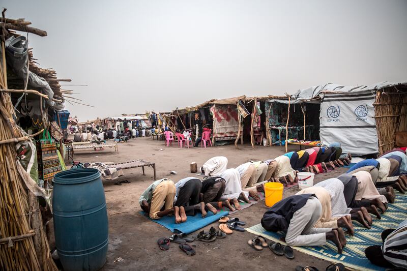 Men pray after breaking their fast, as Ramadan is observed by Sudanese refugees, who have fled Sudan's war, in a transit centre in Renk, South Sudan. Photograph: Sally Hayden