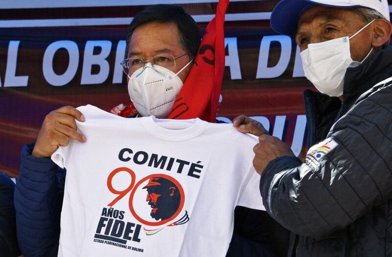 Bolivian president Luis Arce receives a T-shirt with an image of late Cuban leader Fidel Castro on May Day in Oruro.