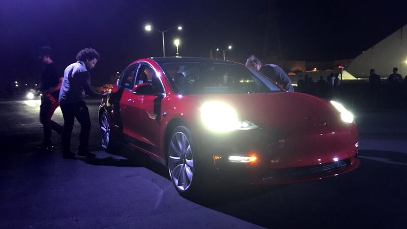 Customer employees receive some of the first Model 3 cars off the Fremont factory’s production line. Photograph: Alexandria Sage/Reuters