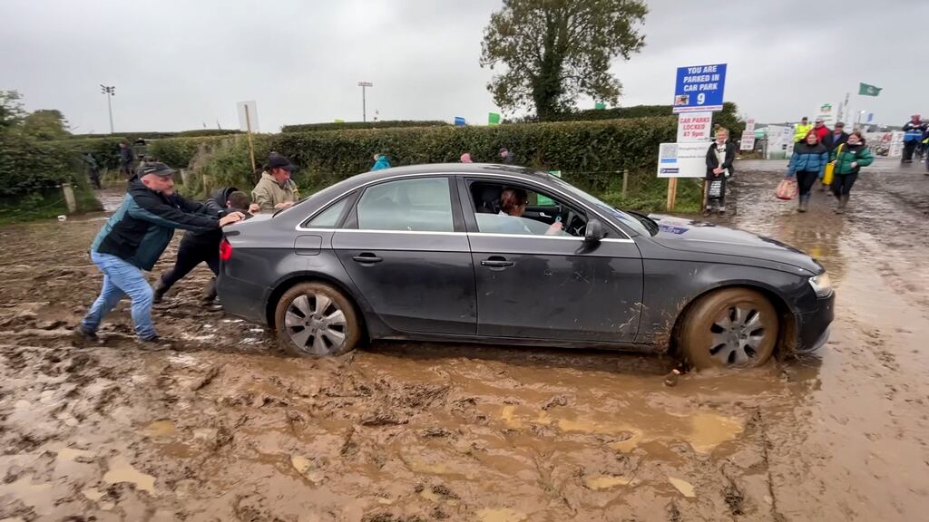 A stuck car being pushed out of mud at the Ploughing Championships at Ratheniska, Co Laois. Photograph: Niall Carson/PA Wire