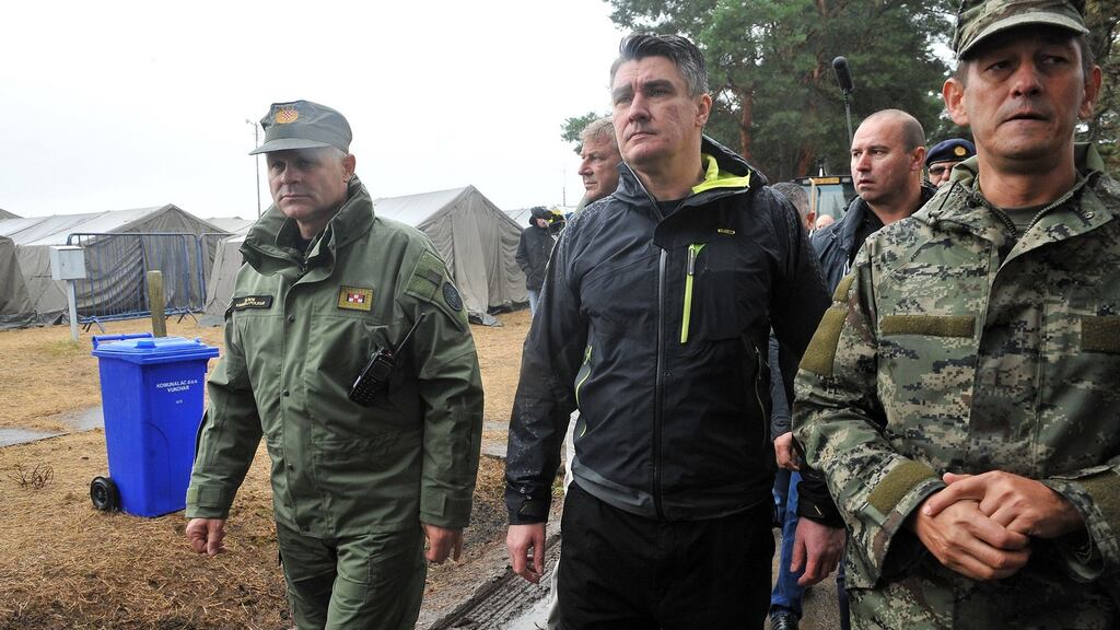 Croatian prime minister Zoran Milanovic (centre) with armed forces officers during a visit to the migrant transit camp in Opatovac. Photograph: AFP/Getty Images