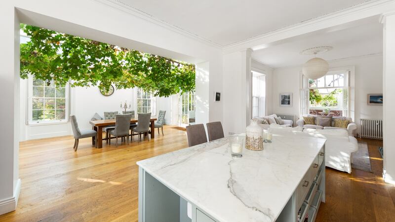 An old conservatory with a rambling vine on the ceiling was converted into a dining room, where the vine, now heavy with grapes is the star attraction