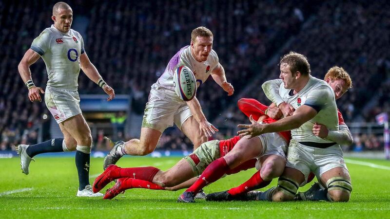 Joe Launchbury offloads to Jonny May. Photograph: James Crombie/Inpho