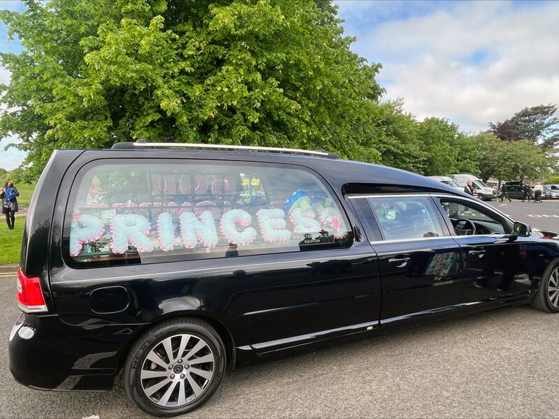 Floral tributes in a hearse outside St. Josephs Church in Galliagh Co. Londonderry during the funeral of Rebecca Browne who died after being hit by a garda patrol car in Co. Donegal. Photograph: Claudia Savage/PA Wire