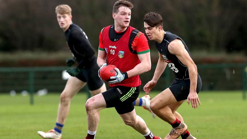 Mayo’s Matt Ruane and Oisin Mullin practice their Aussie Rules skills. Photograph: Bryan Keane/Inpho