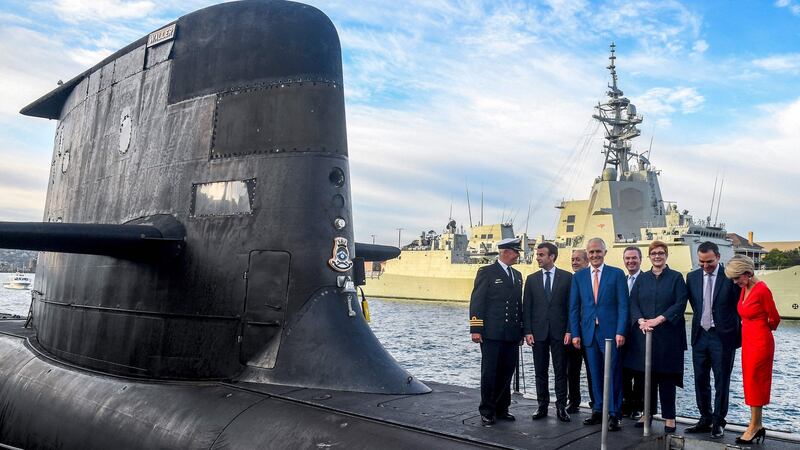French president Emmanuel Macron and then Australian prime minister Malcolm Turnbull (centre) standing on the deck of HMAS Waller, a submarine operated by the Royal Australian Navy, at Garden Island in Sydney in 2018. Photograph: Brendan Esposito/POOL/AFP via Getty Images