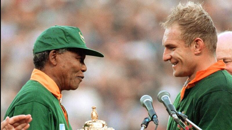South Africa’s president Nelson Mandela hands Francois Pienaar the Webb Ellis Trophy after the Springboks’ World Cup final win over New Zealand in 1995. Photograph: Jean-Pierre Muller/Getty