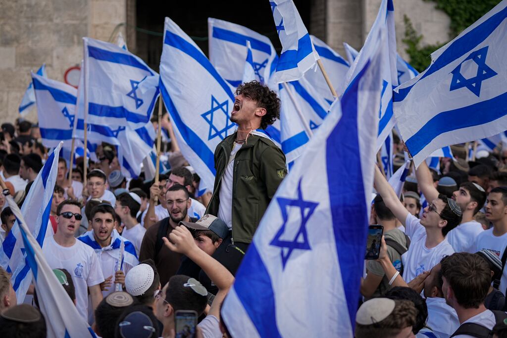Jubilant Israelis wave national flags to mark Jerusalem Day. Photograph: Ohad Zwigenberg/AP
