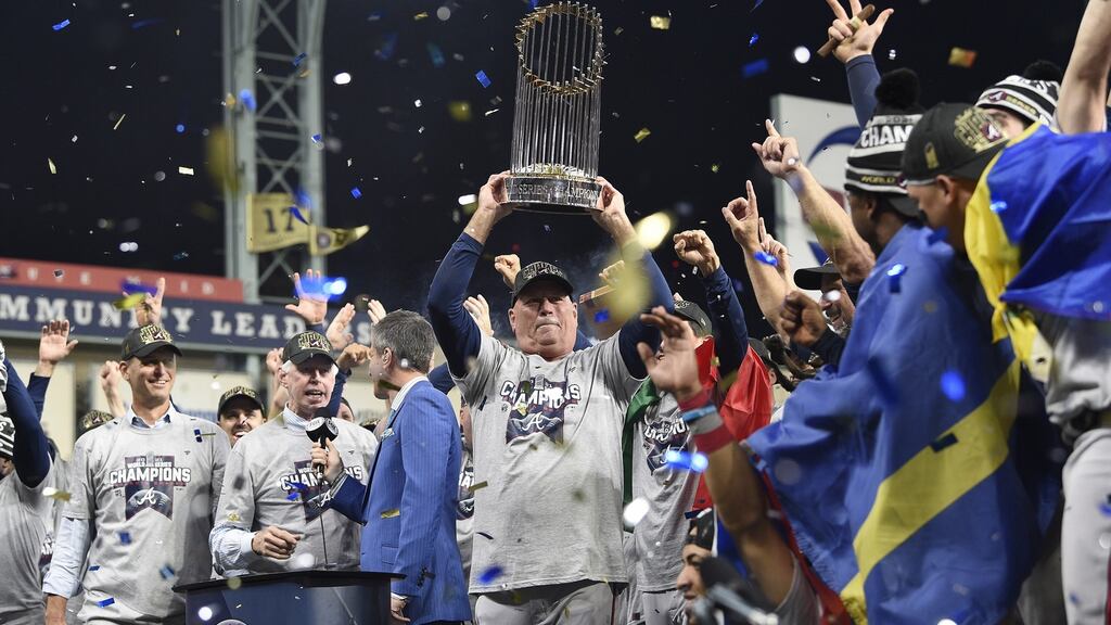 Atlanta Braves manager Brian Snitker hoists the Commissioner’s Trophy after the Braves defeated the Houston Astros in game six of the Major League Baseball World Series. Photo: Ken Murray/EPA