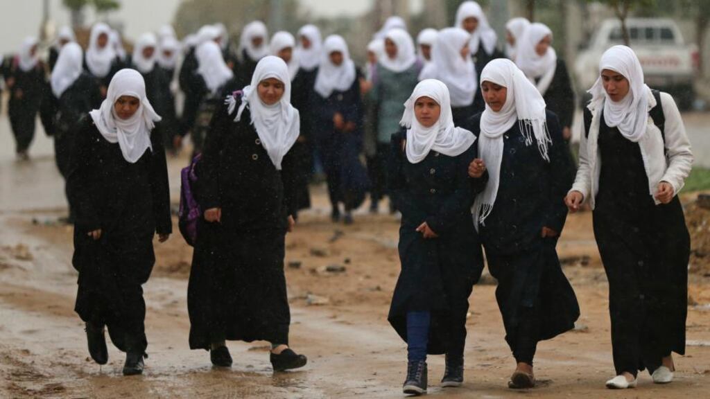 Palestinian school girls return to their houses in Beit Hanoun town in the northern Gaza Strip. Palestinian officials estimate that 100 lorry loads a day of the entire range of building supplies are needed to reconstruct Gaza. Photograph: Mohammed Salem/Reuters
