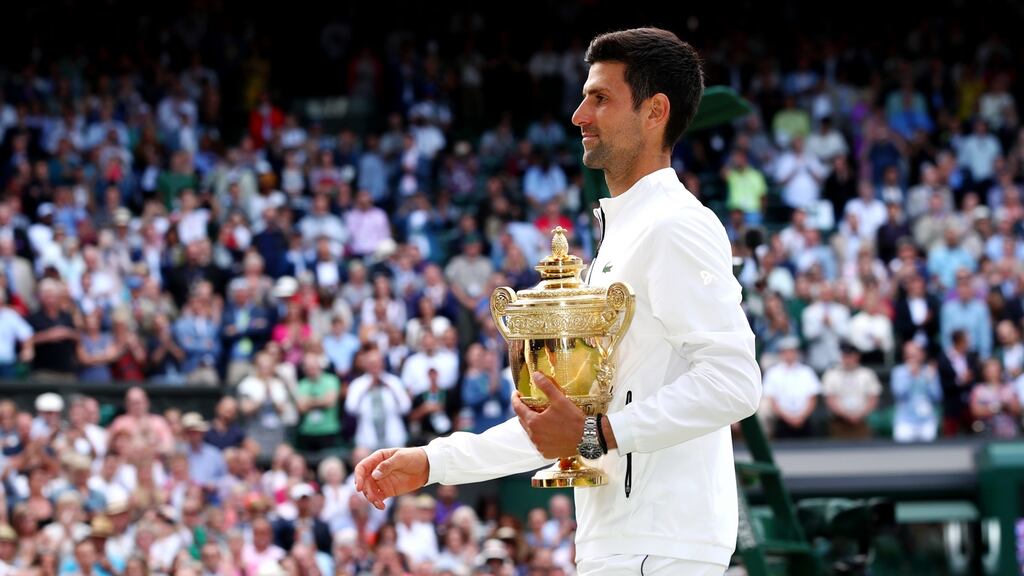Novak Djokovic with the trophy after his Wimbledon victory in 2019. Photograph: Clive Brunskill/Getty
