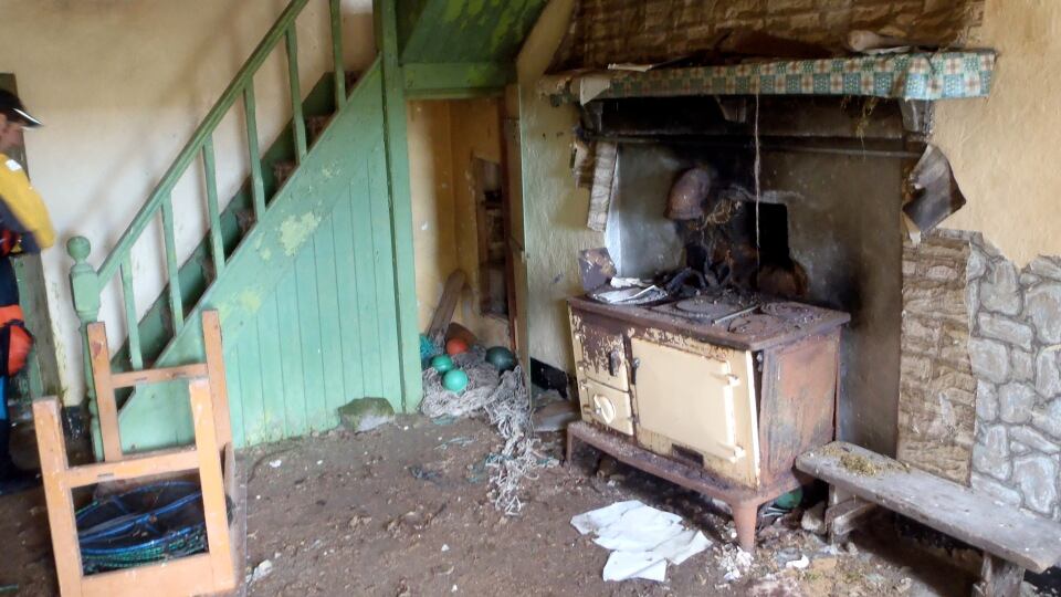 The main living/kitchen area of the house. Fisherman have stored nets and other equipment in the cupboards. Photograph: Gary Quinn