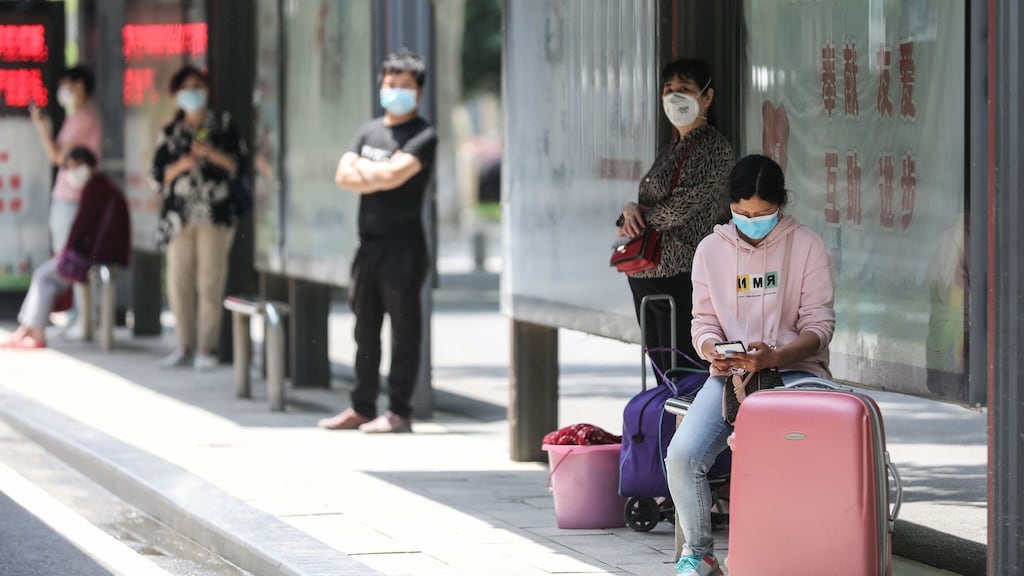 People wait at a bus station in Wuhan, China. Photograph: STR/AFP/Getty