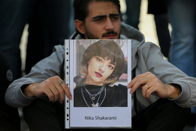 A man holds a photograph of Nika Shakarami, during a demonstration in Naples in support of freedom for Iranian women. Photograph: Marco Cantile/LightRocket via Getty Images
