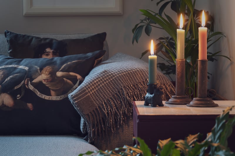 Cashmere merino throw, €129.95, antique brass effect candlesticks, €14.95, Scottie dog candlestick, €9.95, Goya cushion, €39.95, Vermeer cushion, €39.95 and Cherub cushion, €39.95, all from Russborough shop — russborough.ie Photograph: Joanna Barry