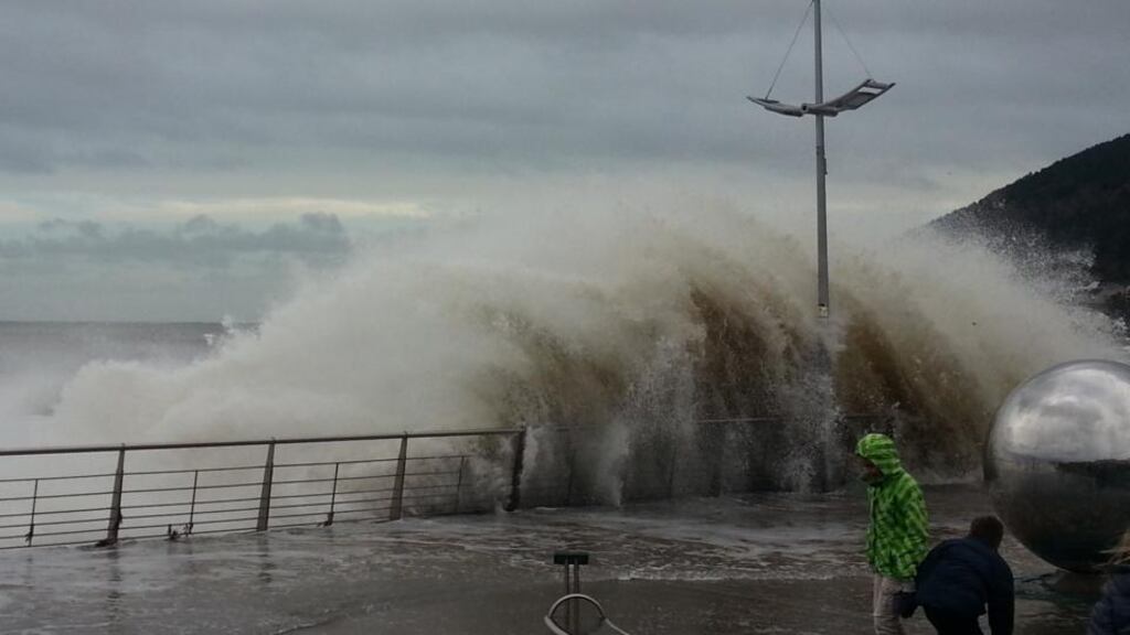 Waves break on the seafront in  Newcastl, Co Down.