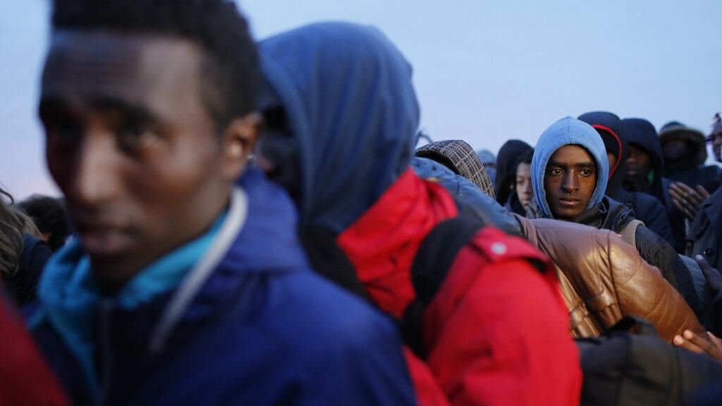 Migrants wait for evacuation in Calais on Monday. “They are apprehensive and don’t know what lies ahead,” says Irish volunteer Caoimhe Butterly. Photograph: EPA/Thibault Vandermersch