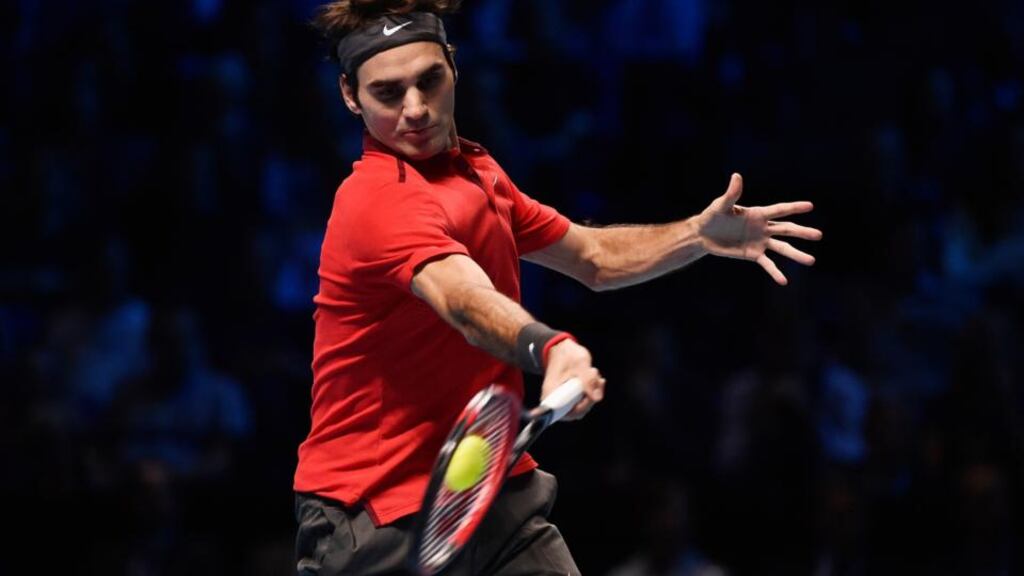 Roger Federer returns the ball during his match against Andy Murray at the ATP World Tour finals at the O2 Arena in London. Photograph: Toby Melville/Reuters
