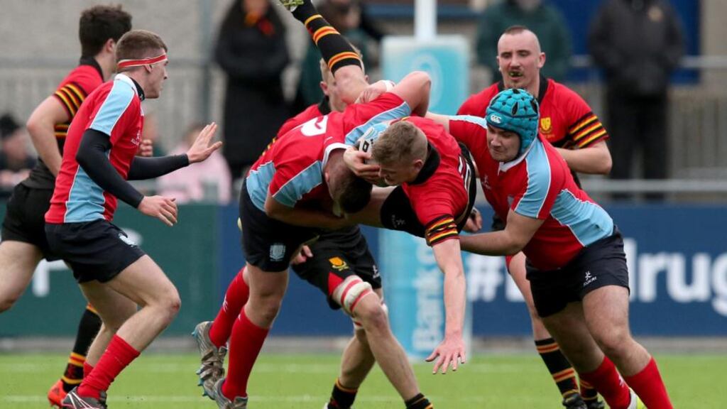 CUS’s Dave Byrne and Darragh O’Neill join forces to tackle CBC Monkstown’s Hugh O’Neill during yesterday’s Leinster Schools Senior Cup first round clash at Donnybrook. Photograph: Ryan Byrne/Inpho