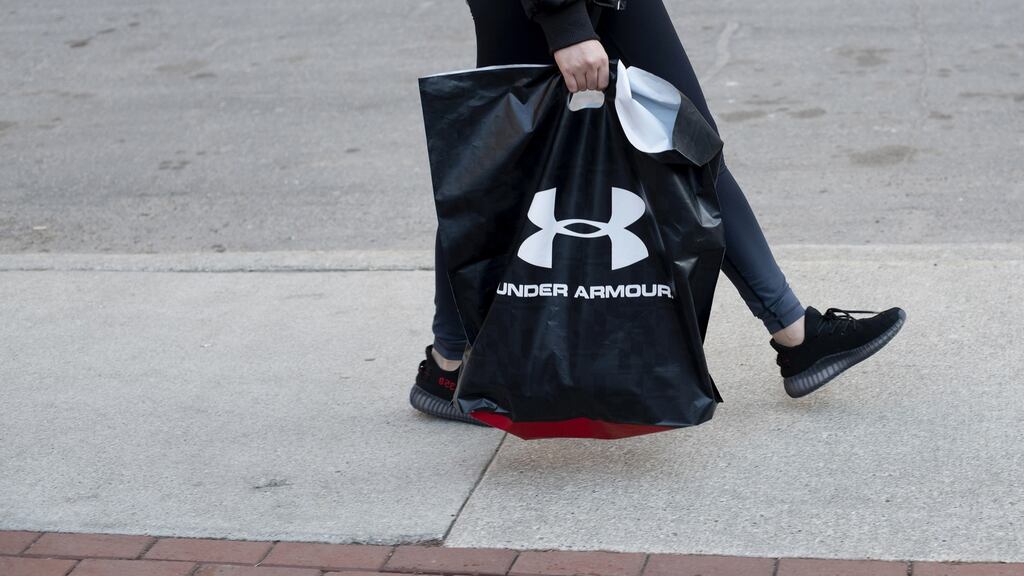 A pedestrian carries an Under Armour, shopping bag in Detroit, Michigan. Under Armour topped Wall Street forecasts for first-quarter revenue on Tuesday. Photographer: Rachel Woolf/Bloomberg