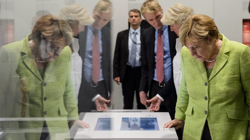 Angela Merkel at the former prison of the Stasi, in Berlin. Photograph: Jens Schlueter/EPA