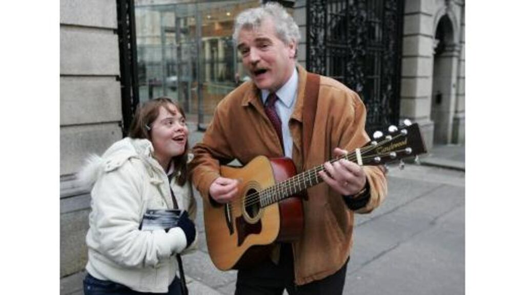 Finian McGrath with his daughter, Cliodhna, outside Leinster House yesterday, where the Independent TD launched his new CD, 'Angels We Have Heard on High', in aid of Down Syndrome Ireland.
