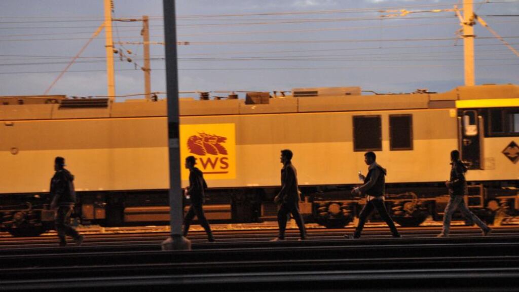Migrants walk along the railway tracks of the Eurotunnel terminal at the Calais-Frethun station outside the northern French port of Calais on August 10th, 2015. Photograph: FRANCOIS LO PRESTI/AFP/Getty Images