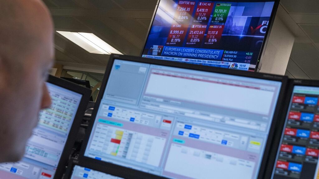 A television screen displays news footage relating to the result of France’s presidential election, as traders works on the trading floor of ETX Capital in London on May 8th. Photograph: Chris Ratcliffe/AFP/Getty Images