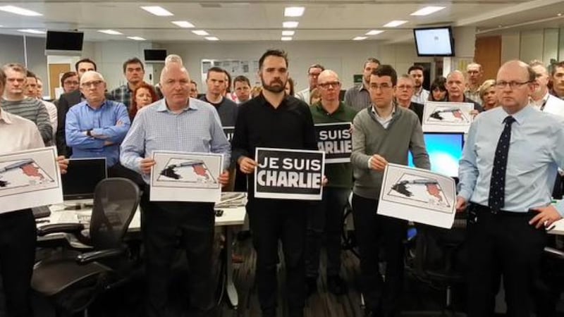 Journalists in the newsroom at The Irish Times observing a minute’s silence at 11am to mark the killings at Charlie Hebdo in Paris. Photograph: Frank Miller/The Irish Times