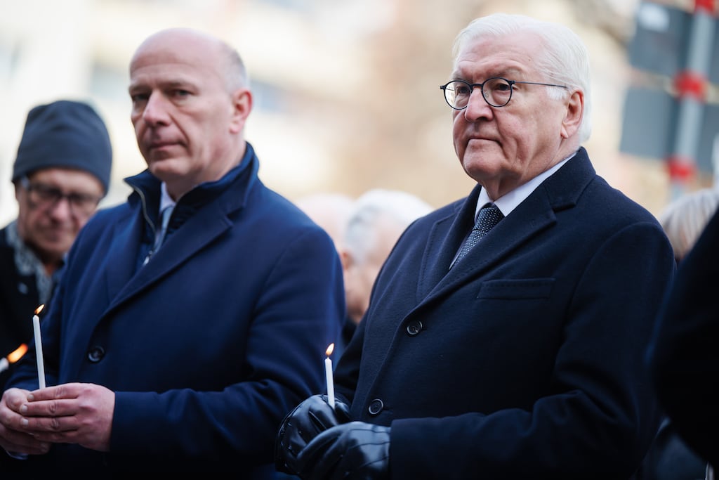 Berlin governing mayor Kai Wegner and German president Frank-Walter Steinmeier stand with candles during a commemorative event on the 35th anniversary of the fall of the Berlin Wall. Photograph: Clemens Bilan/Getty Images