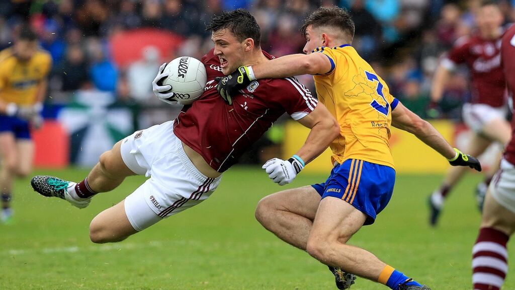 Damien Comer of Galway is stopped by Sean Mullooly of Roscommon during last Sunday’s drawn Connacht final. Photo: Donall Farmer/Inpho