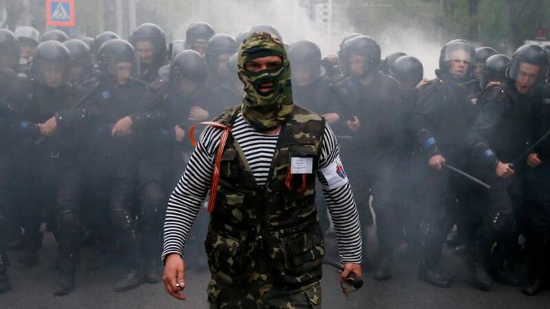 A pro-Russian activist walks in front of Ukrainian riot police during a pro-Ukrainian rally in the eastern city of Donetsk today. Photograph: Marko Djurica/Reuters