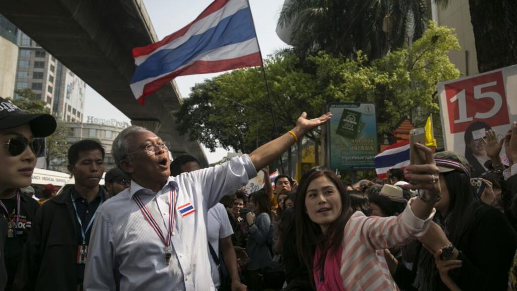 Anti-government leader Suthep Thaugsuban greets his supporters as he parades through the city while the Bangkok state of emergency continues. Photograph: Paula Bronstein/Getty Images