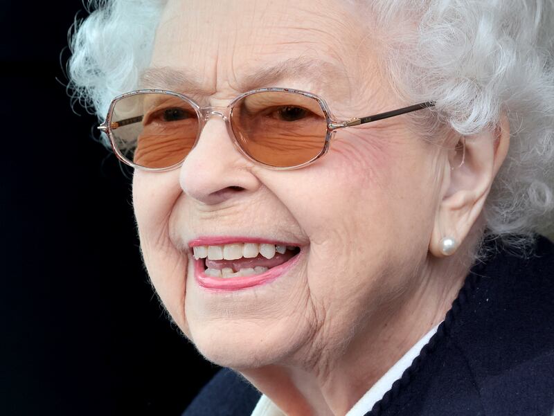 Queen Elizabeth II watches the horses from her Range Rover at The Royal Windsor Horse Show at Home Park in May 2022 in Windsor,