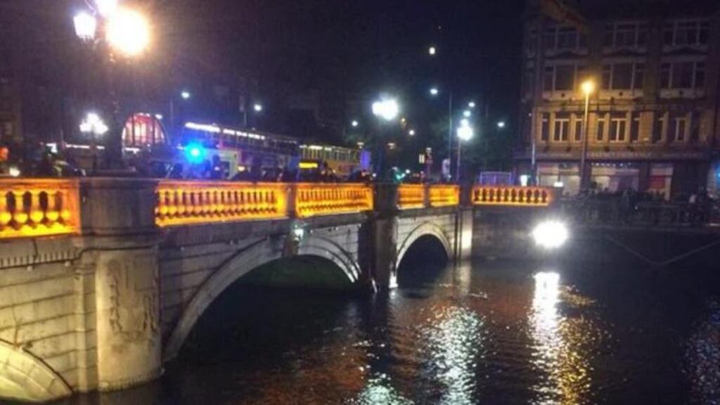 Emergency services rescue man from the River Liffey near O’Connell Bridge in Dublin.