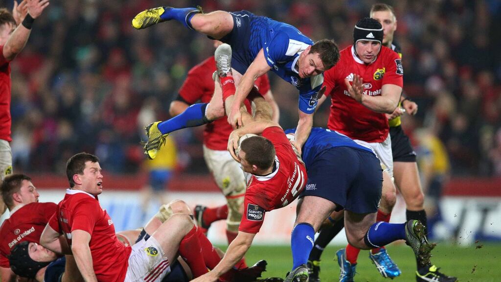 Leinster’s Eoin Reddan and Munster’s Andrew Conway are upended during the Guinness Pro12 game at Thomond Park last night. Photograph: Billy Stickland/Inpho