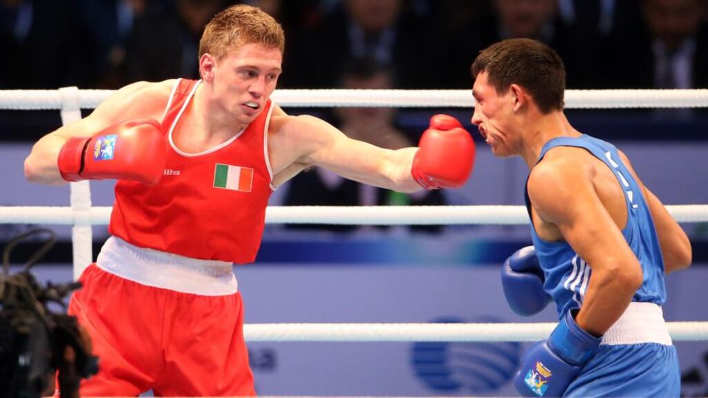 Ireland’s Jason Quigley on his way to defeat  against Zanibek Alimkhanuly  of Kazakhstan during their middleweight final clash. Photograph: Cathal Noonan/Inpho