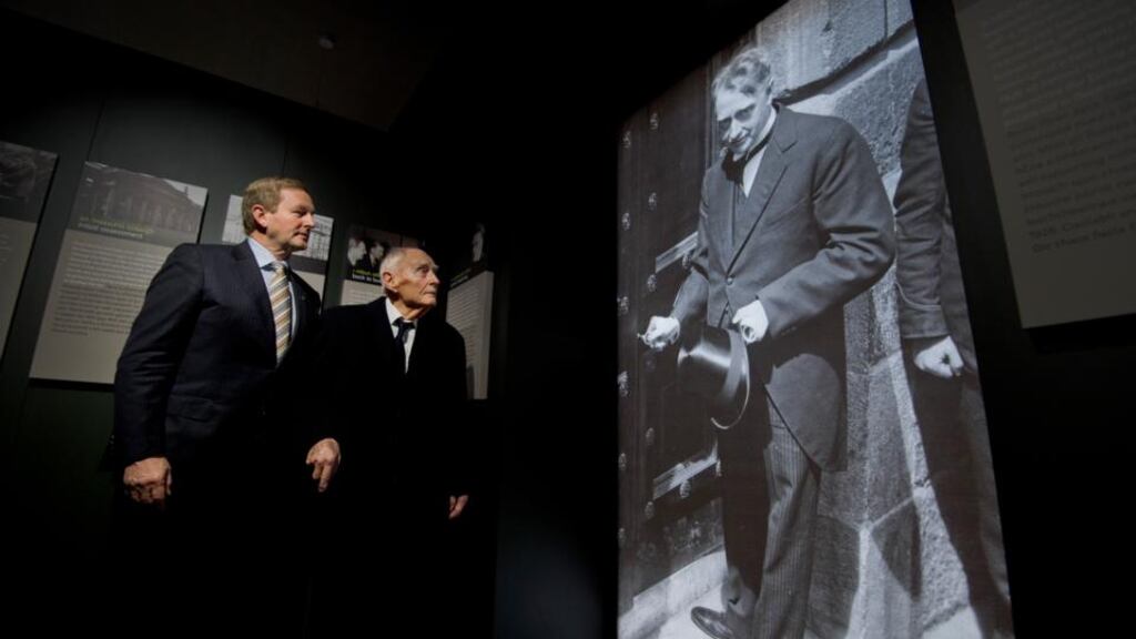 Acting Taoiseach Enda Kenny and former taoiseach Liam Cosgrave study a photograph of WT Cosgrave at the official opening of the GPO Witness History exhibit. Photograph: Brenda Fitzsimons/The Irish Times